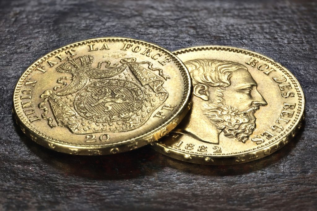 Pièces belges de 20 francs or sur fond de bois rustique
